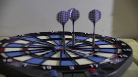 Competitors throw at target with blue and pink arrows 10 Stock Footage 60030411