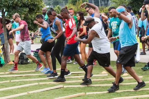 Competitors Try To Keep Their Balance In Field Day Game Stock Photos