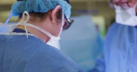 Compilation of Surgeons operating together on a patient Stock Footage 146646592
