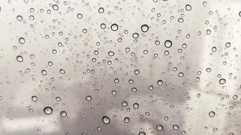 Compilation of videos of raindrops on a transparent window showing a city Stock Footage 134334237