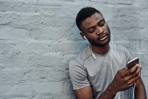 Compiling the perfect workout playlist Stock Photos