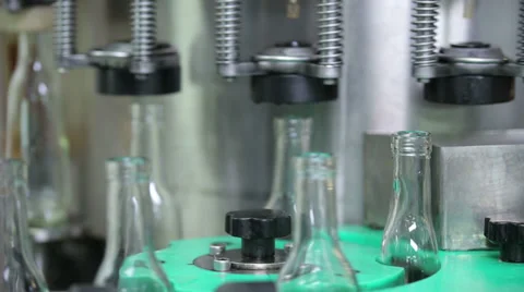 Complete and empty bottles of cognac on a conveyer Stock Footage 33776708