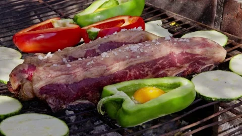 Complete barbecue with coarse salted beef, egg-stuffed peppers Stock Footage 238627946