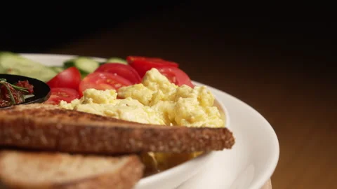 Complete breakfast with scrambled eggs, toast, cheese, and fresh salad Stock Footage 338390234