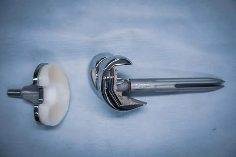 Complete explanted knee prosthesis consisting of distal and proximal parts Stock Photos