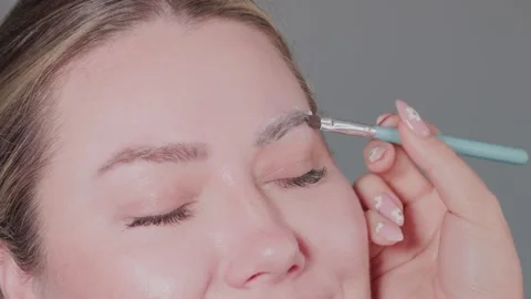 The Complete Eyebrow Grooming Process Featuring Expert Brush Technique for Stock Footage 315858137