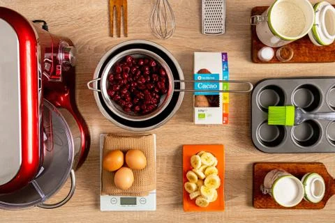 Complete ingredients and kitchen tools for making banana-cherry muffin Stock Photos