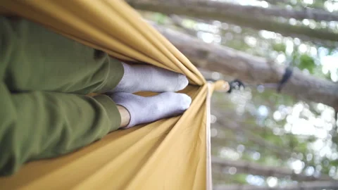 Complete relaxation on a hammock in the forest vertical video Stock Footage 233085577
