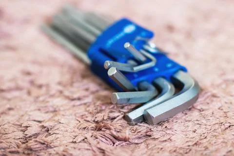 A complete set of various allen wrenches neatly arranged in a blue case Stock Photos