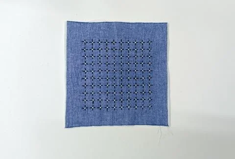 Completed geometric sashiko embroidery pattern on blue fabric Stock Photos