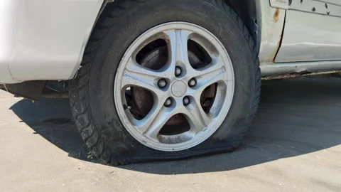 Completely deflated tire on a car Stock Footage 289899886