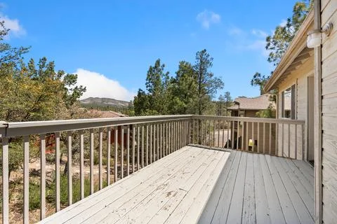 A completely empty deck featuring a railing with trees visible in the background Stock Photos