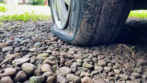 Completely flat tire on a car, road breakdown, accident Video stock 317016419
