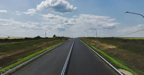 Completely new two-lane strip of road far away from city Stock Footage 257428766