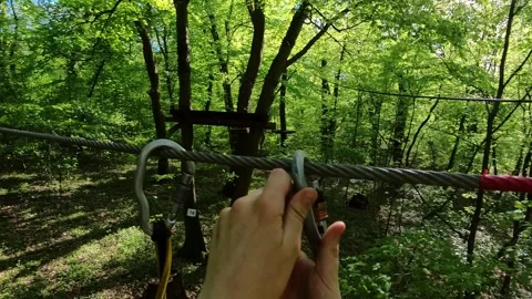 Completing challenges in a treetop adventure park Stock Footage 310735631