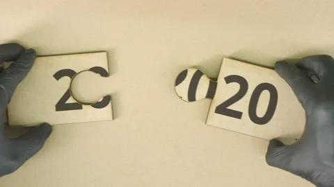 Completing jigsaw puzzle with 2020 text Stock Footage 141948121
