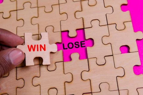 Completing a puzzle piece representing win or lose concept Photos