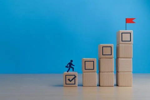 Completing tasks, projects, goal achievement icon on wood block Stock Photos