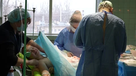 Completion of the caesarean section. The mother is smiling. Stock Footage 235468670
