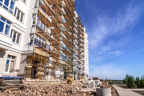 Completion of residential building construction facade finishing using scaffo Stock Photos