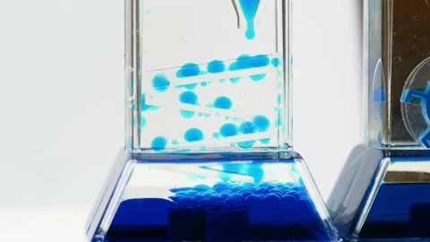 Complex blue fluid hourglass machine, time flow concept, liquid drops falling Stock Footage 169759392