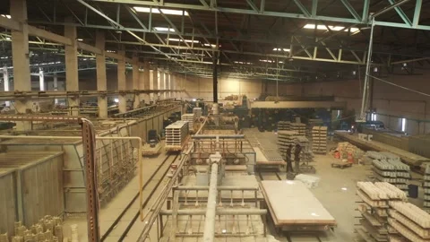 Complex conveyor tracks thousands of ceramic mugs stacked on trussed warehouse Stock Footage 328155553