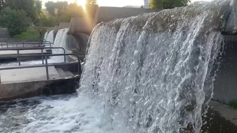 Complex of decorative waterfalls in the city park of Minsk in the rays of the se Stock Footage 315086755