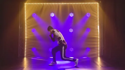 Complex elements of breakdancing performed by a professional male dancer in a Stock Footage 138916826