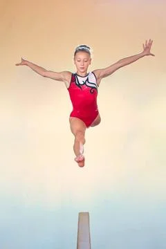 Complex elements of gymnastics girls training in the gym Stock Photos