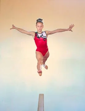 Complex elements of gymnastics girls training in the gym Stock Photos