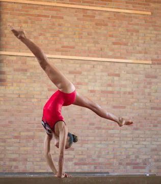 Complex elements of gymnastics girls training in the gym Stock Photos