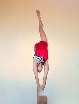 Complex elements of gymnastics girls training in the gym Stock Photos