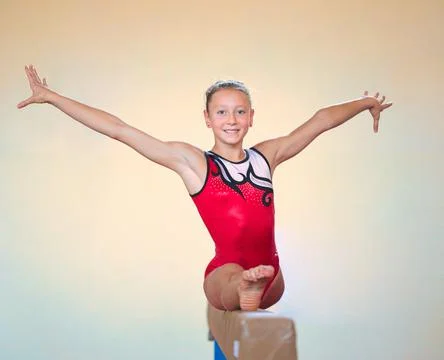 Complex elements of gymnastics girls training in the gym Stock Photos