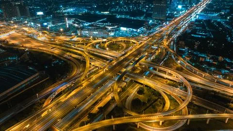 Complex Elevated Multi-level Highway Interchange With Glowing Traffic Light.. 库存照片