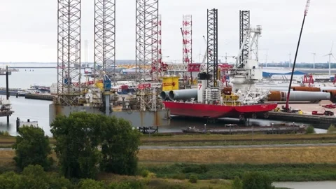 Complex engineering red installation ship grey jack up platform highlighted Stock Footage 327657175