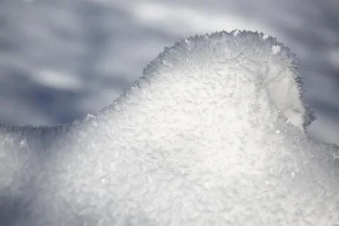Complex glittering ice flowers on a heap of snow after a freezing night in th Stock Photos