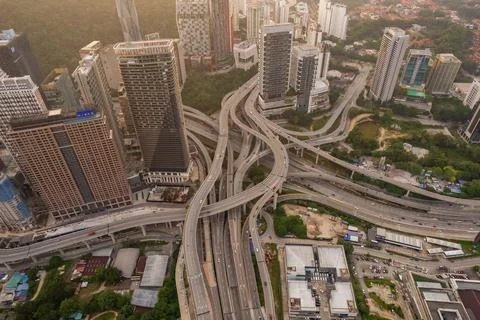 A complex highway network weaves through a dense urban landscape Foto stock