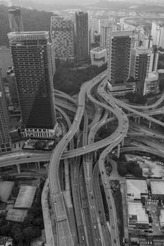 A complex highway network weaves through a dense urban landscape Foto stock