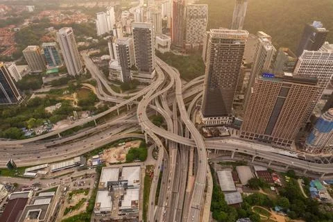 A complex highway network weaves through a dense urban landscape 스톡 사진