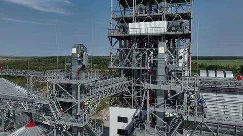 Complex industrial facility with storage silos and piping system. A detailed Stock Footage 296052243