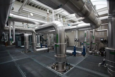 Complex of isolated piping inside of industrial heating plant - pipelines. Stock Photos
