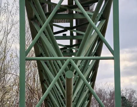 Complex Lattice Framework With Green Steel Braces Against Cloudy Sky Backgr.. Stock-Fotos