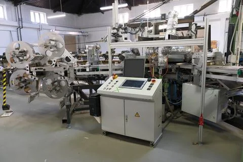 A complex machine stands in a factory hall Stock Photos