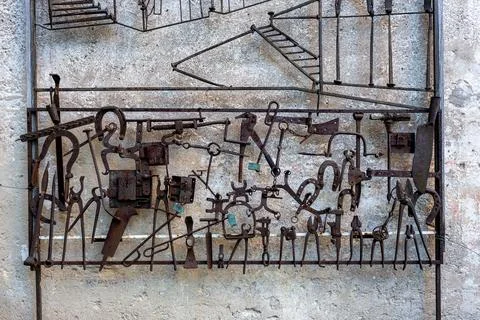 A complex metal artwork with various tools and details forged from iron cen.. Stock Photos