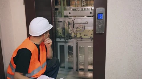 Complex modern elevator equipment, the engineer solves the problem and thinks Stock Footage 266229623