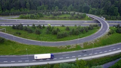 Complex motorway intersection - aerial raising, truck passing 動画素材 155634178
