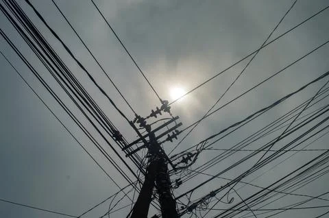 A complex network of electricity and communication wires crisscrosses the s.. Stock Photos