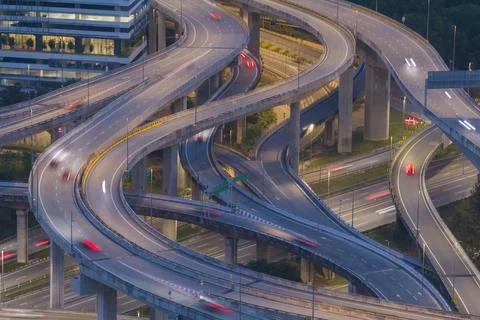 A complex network of elevated highways curves through a modern city 스톡 사진