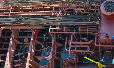 Complex Network of Industrial Pipes and Machinery on Ship Deck Stock Photos