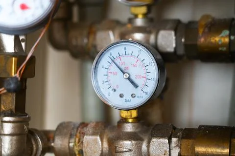 Complex piping system with hot analog pressure gauge with dust, dirt, dirty Stock Photos